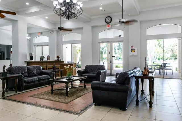 a kitchen with stainless steel appliances granite countertop a refrigerator a sink a stove a washer dryer and cabinets