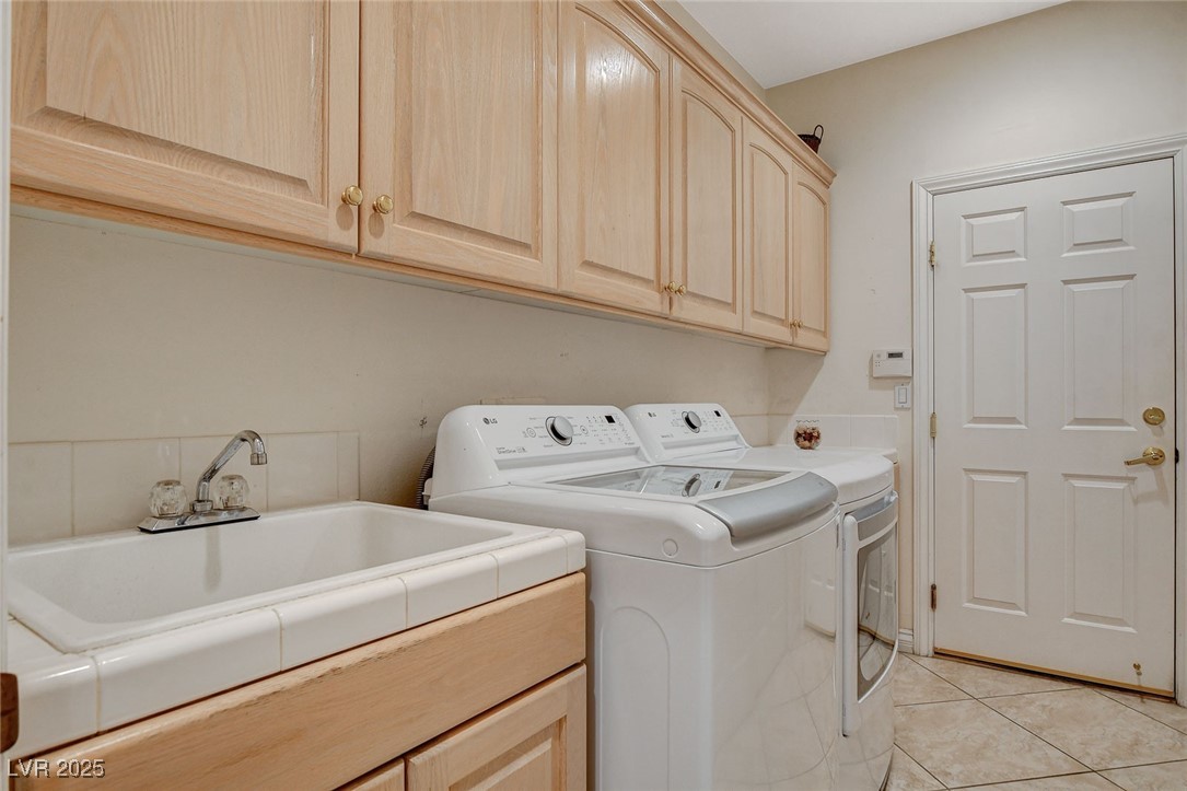 1028 Norellat Road Henderson, NV 89011 - Photo 59 of 74 Laundry with cabinets and sink. Washer and dryer included.