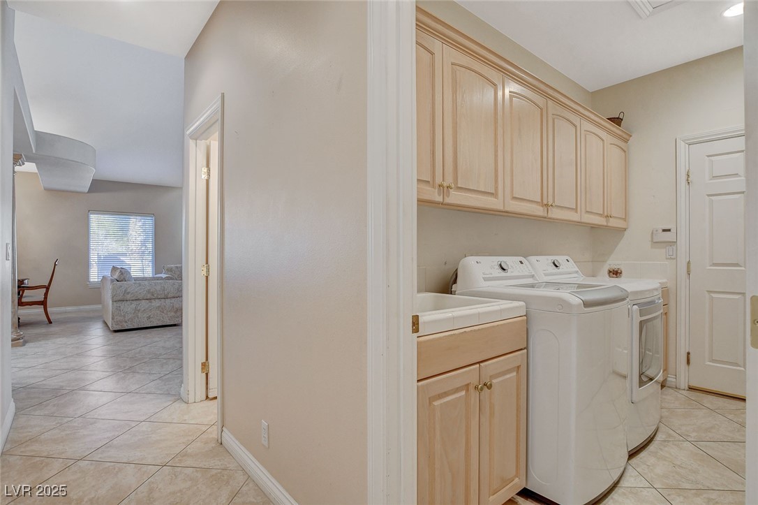 1028 Norellat Road Henderson, NV 89011 - Photo 60 of 74 Laundry with cabinets and sink. Washer and dryer included.