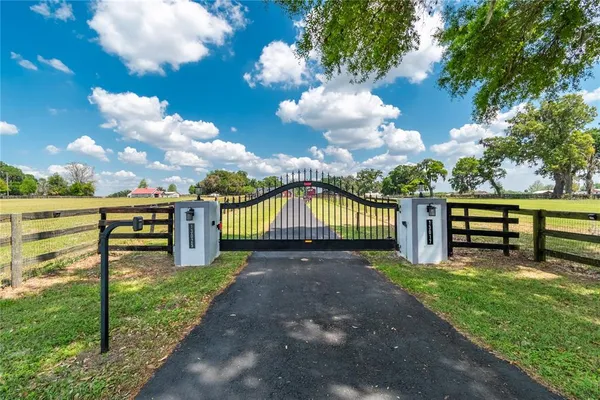 a front view of a house with yard and green space