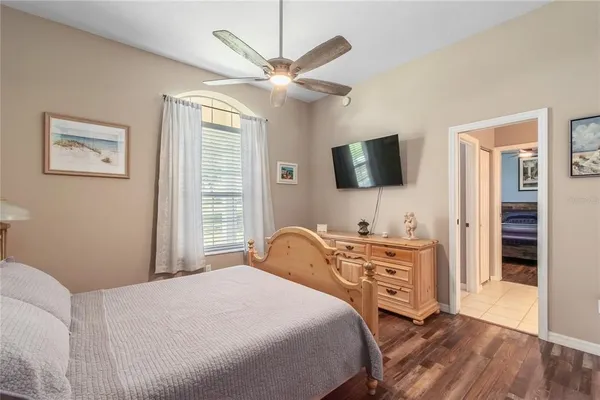 a kitchen with a refrigerator a sink and wooden floor