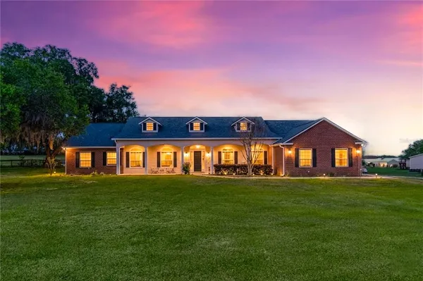 a view of a dining room with furniture and a chandelier