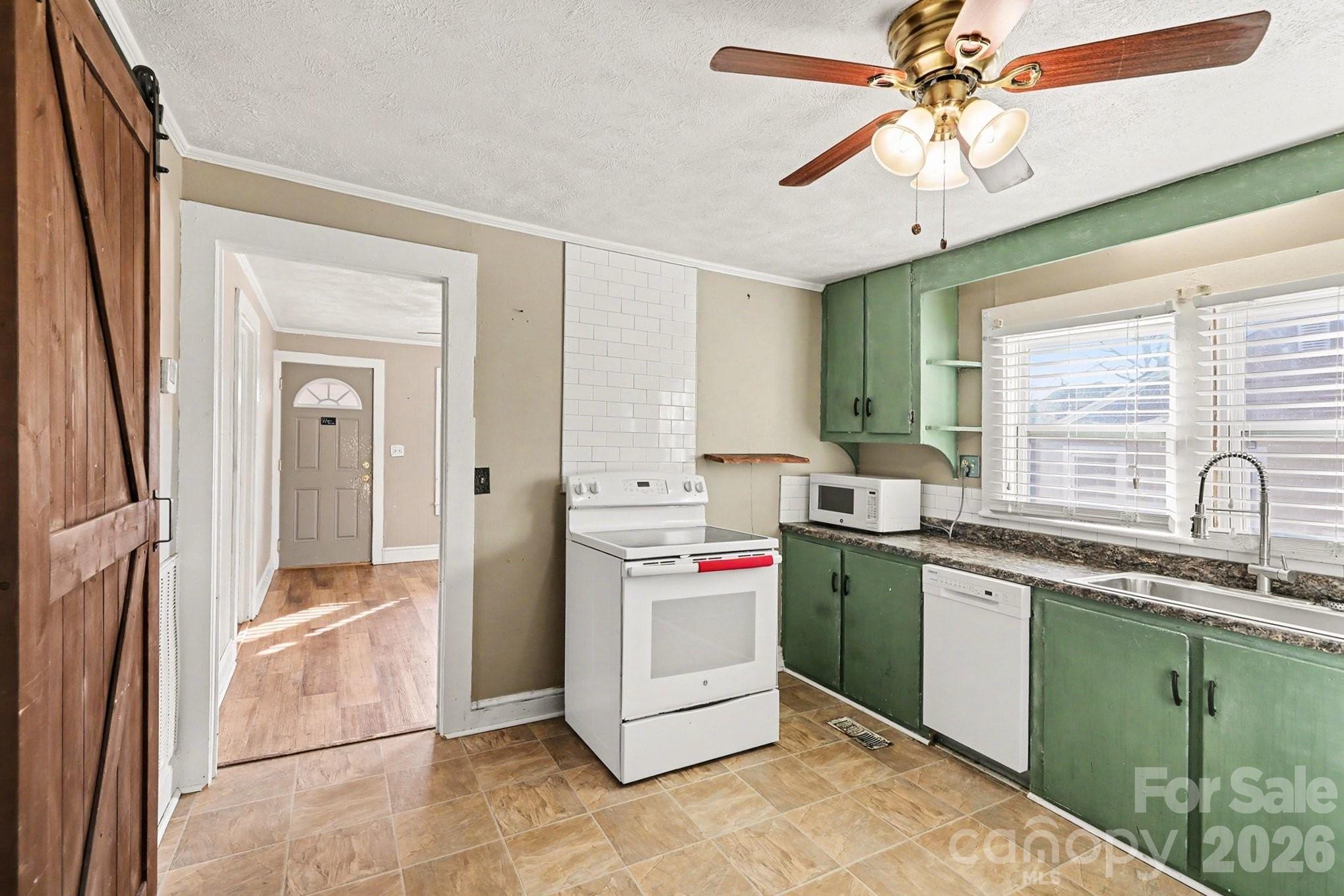 409 South Maple Street Dallas, NC 28034 - Photo 12 of 16 a kitchen with a stove and a sink