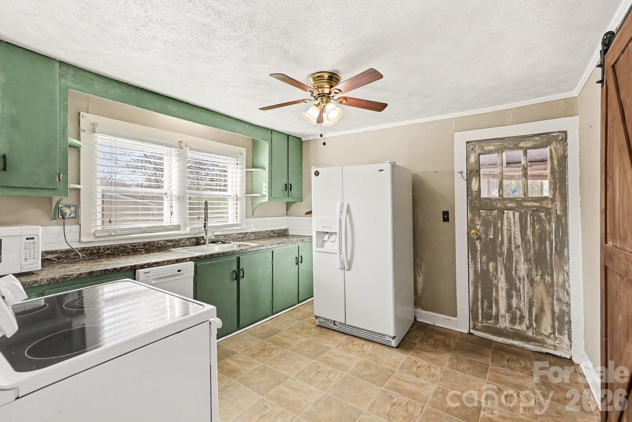 409 South Maple Street Dallas, NC 28034 - Photo 13 of 16 a kitchen that has a refrigerator and a sink
