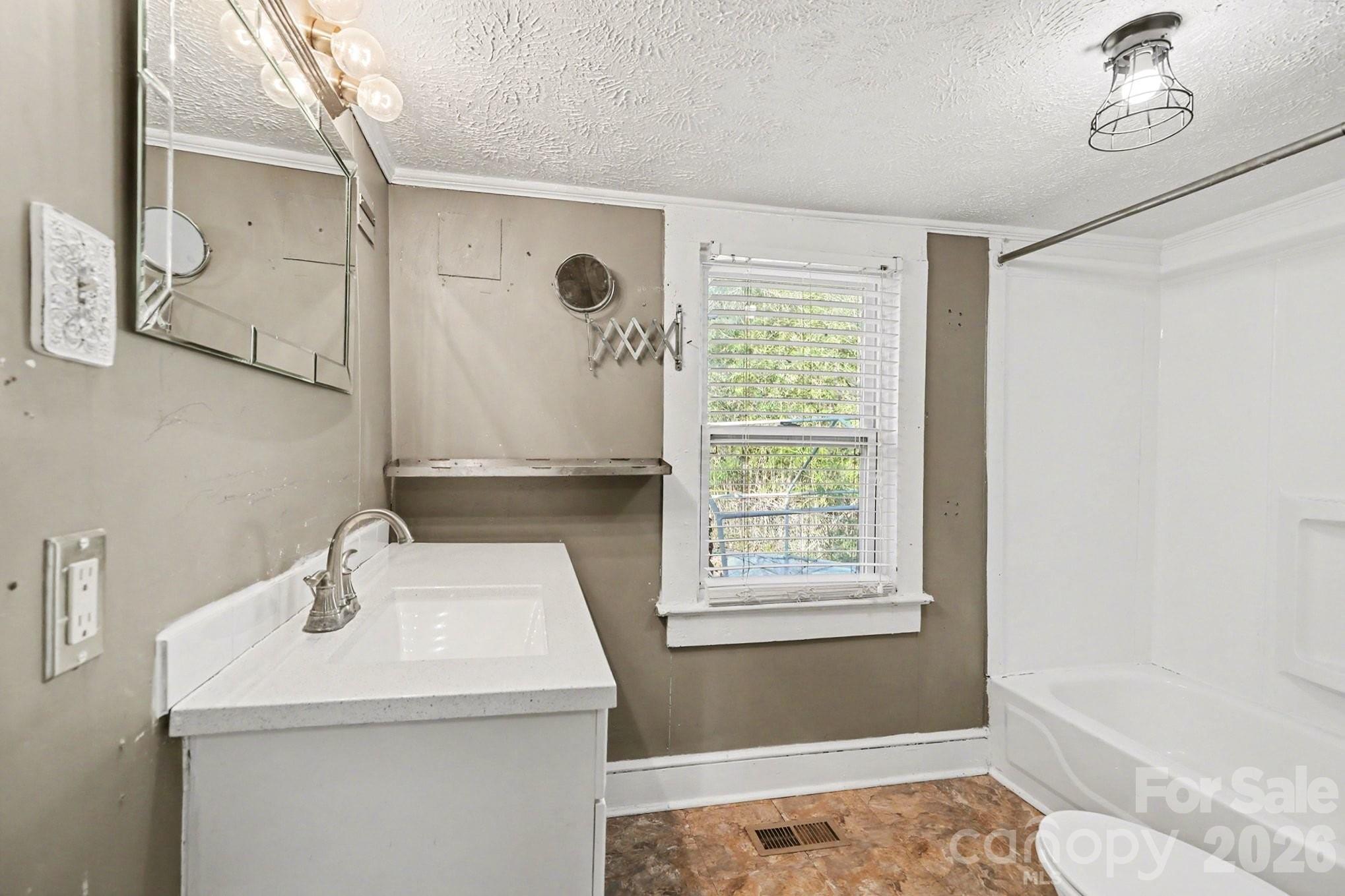 409 South Maple Street Dallas, NC 28034 - Photo 14 of 16 a bathroom with a sink a toilet and shower