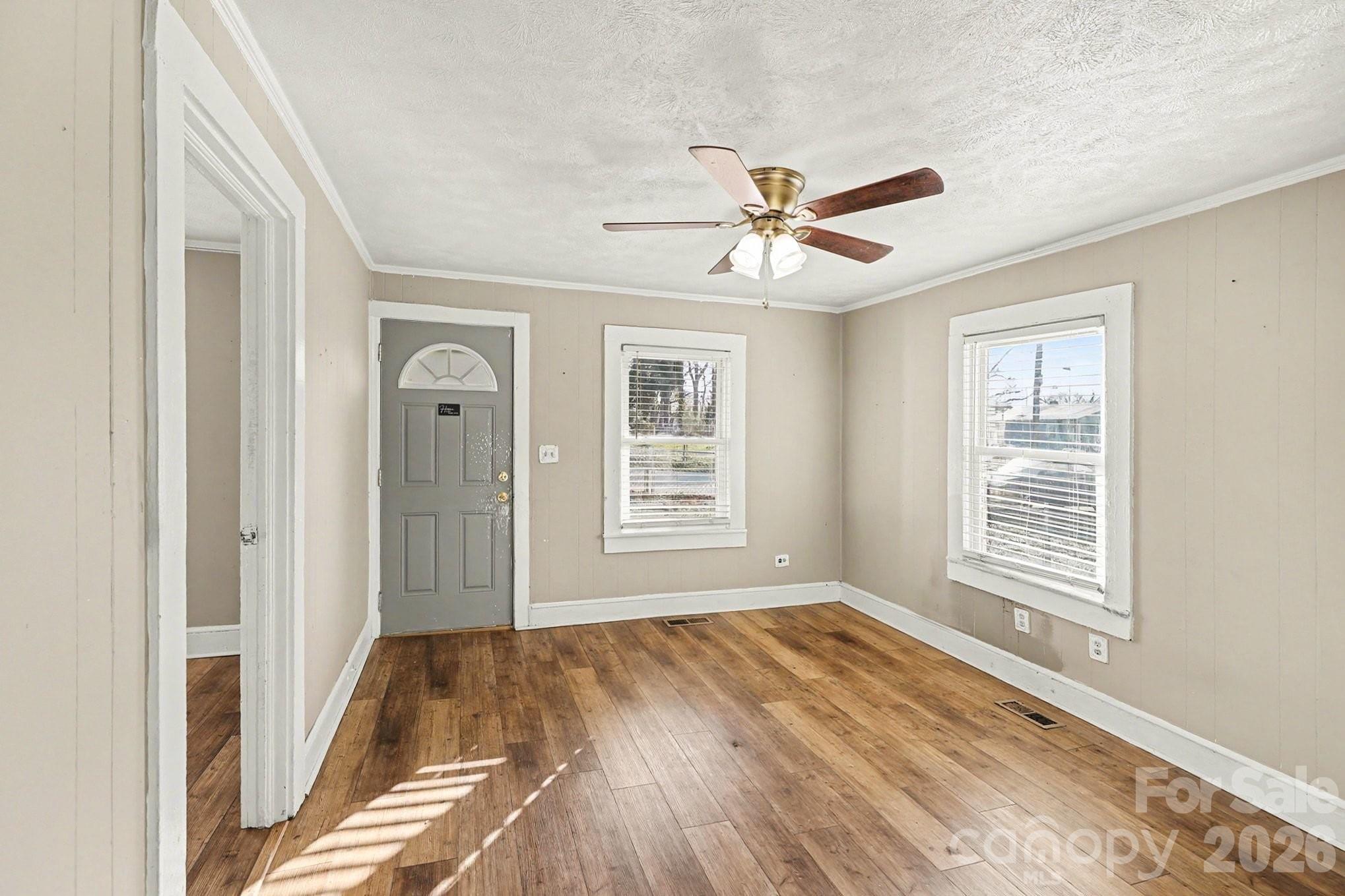 409 South Maple Street Dallas, NC 28034 - Photo 3 of 16 a view of empty room with wooden floor and fan