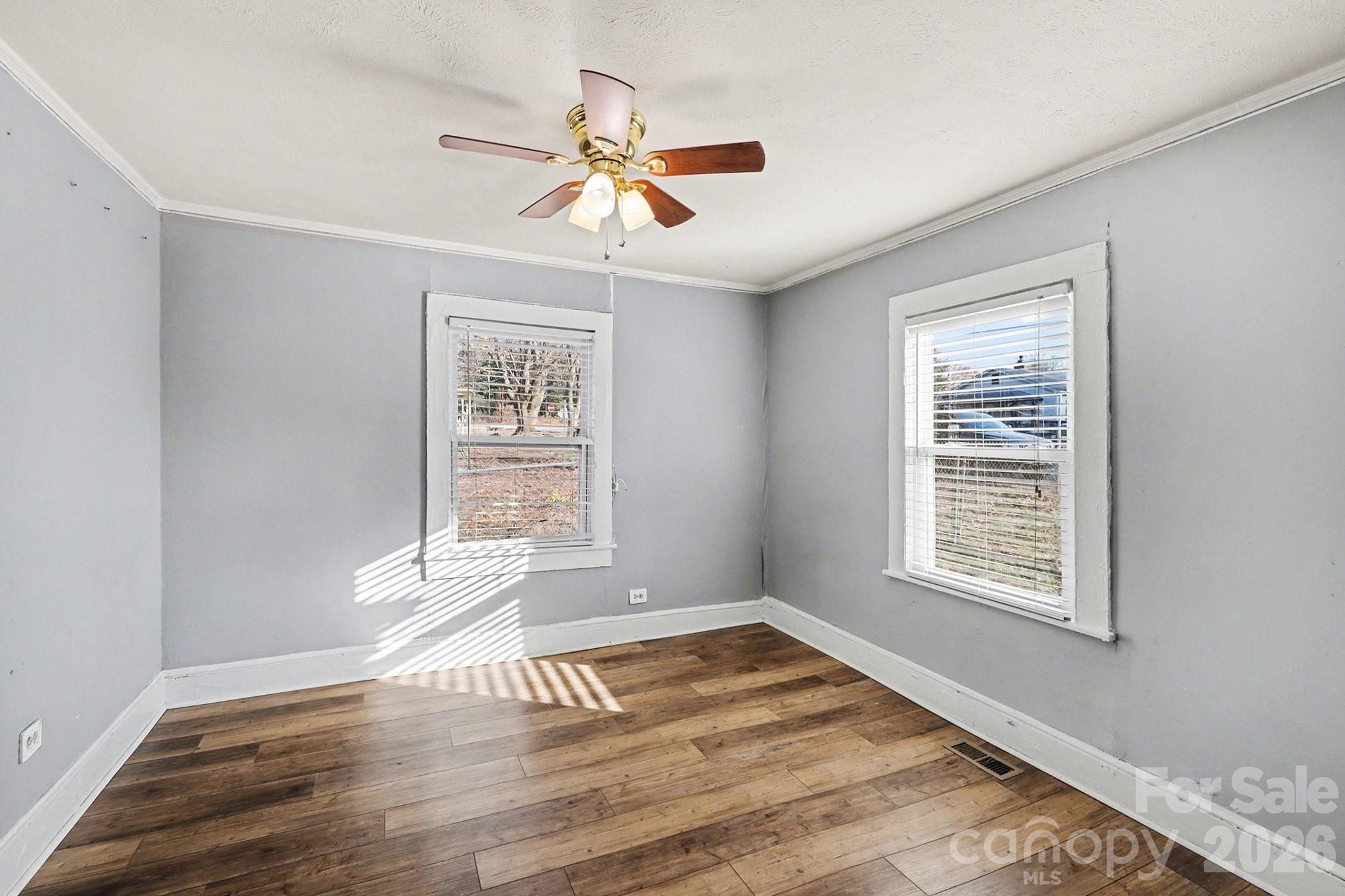 409 South Maple Street Dallas, NC 28034 - Photo 5 of 16 a view of an empty room with wooden floor and a window