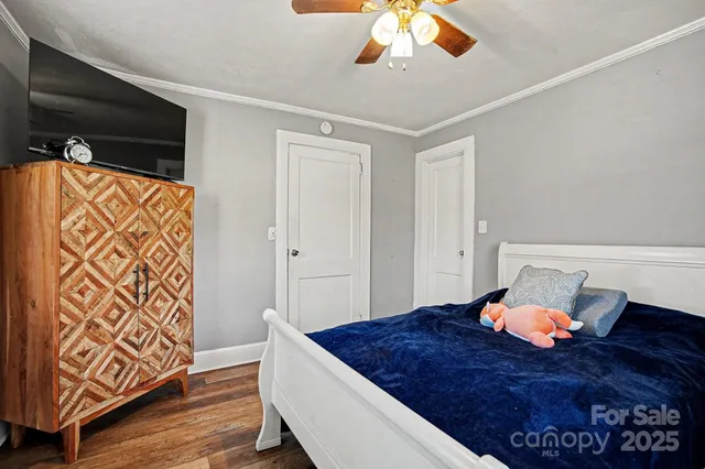 a bedroom with a bed and a lamp on the dresser