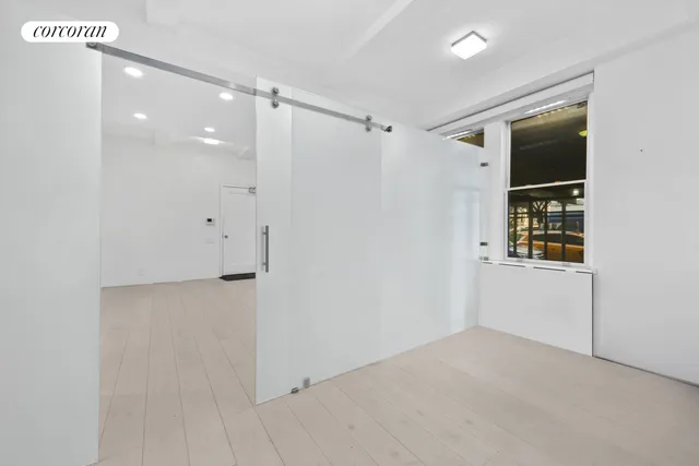 a view of empty room with floor to ceiling window