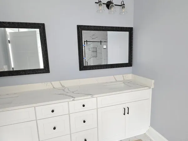 a bathroom with a sink vanity and mirror