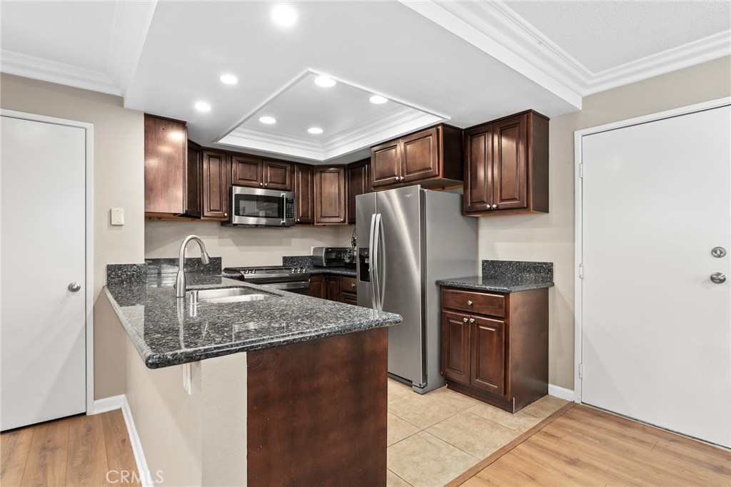 28126 Seco Canyon Road Saugus, CA 91390 - Photo 7 of 30 a kitchen with stainless steel appliances granite countertop a refrigerator a stove a sink a oven and a refrigerator