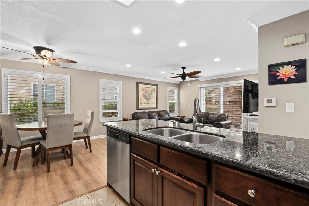 28126 Seco Canyon Road Saugus, CA 91390 - Photo 9 of 30 a open kitchen with granite countertop a sink and dishwasher with wooden floor