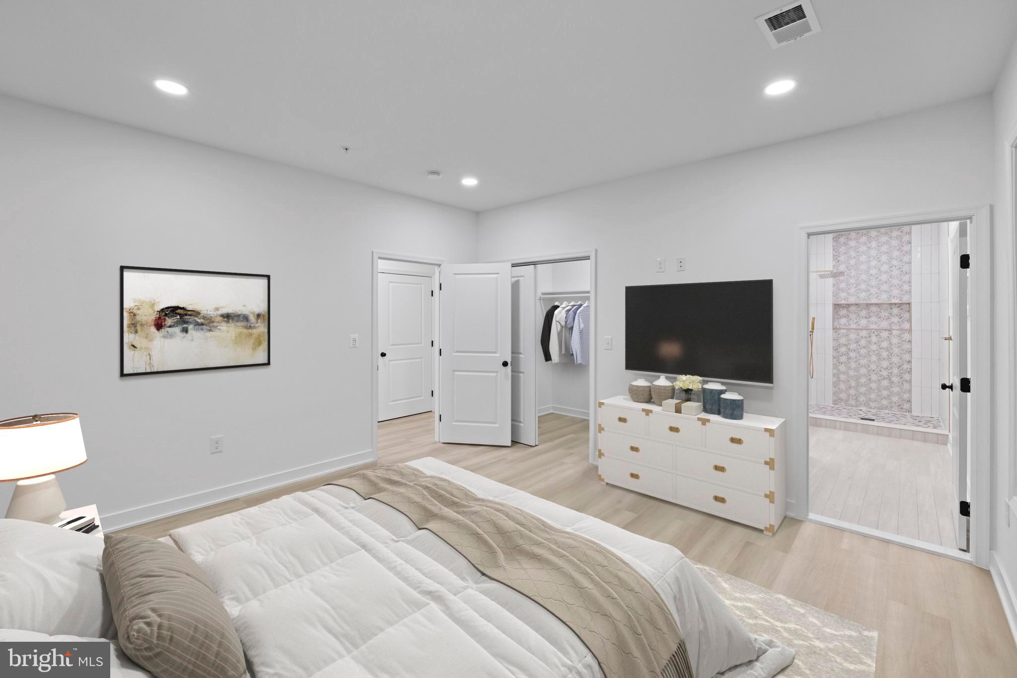 235 Brock Bridge Road Laurel, MD 20724 - Photo 12 of 59 a bedroom with a bed and a flat screen tv