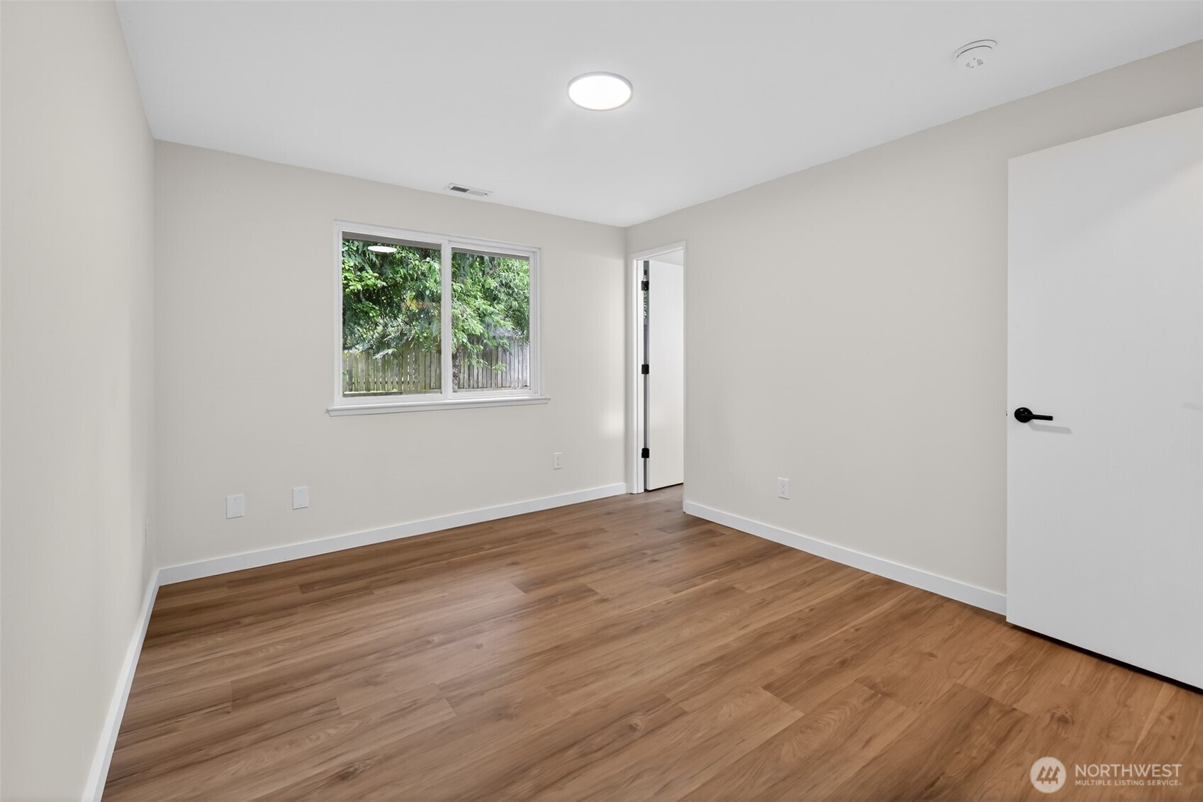 320 213th Place Southwest Bothell, WA 98021 - Photo 16 of 29 an empty room with wooden floor and windows