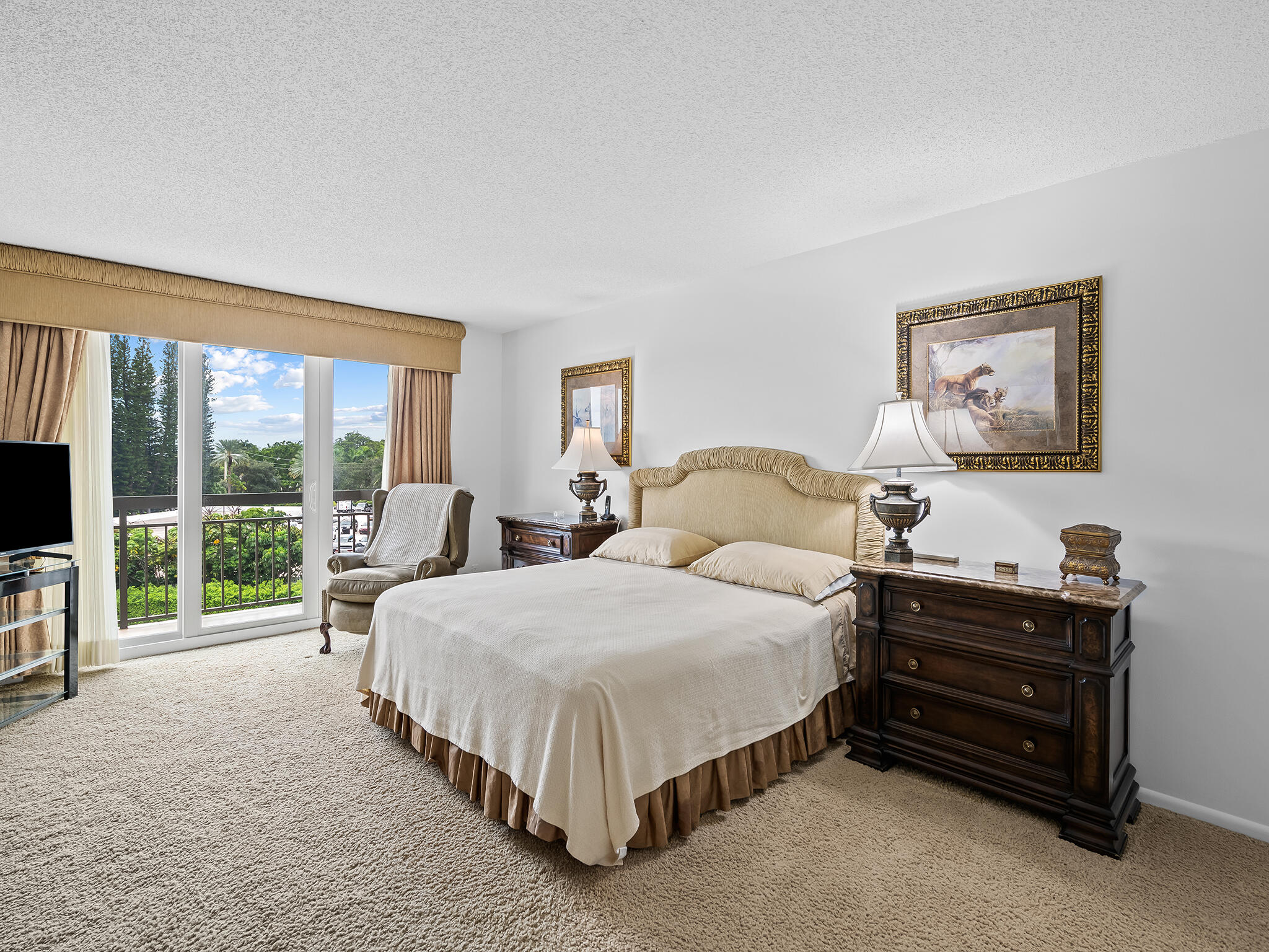 901 East Camino Real, Unit 4D Boca Raton, FL 33432 - Photo 16 of 37 a spacious bedroom with a bed and a large window
