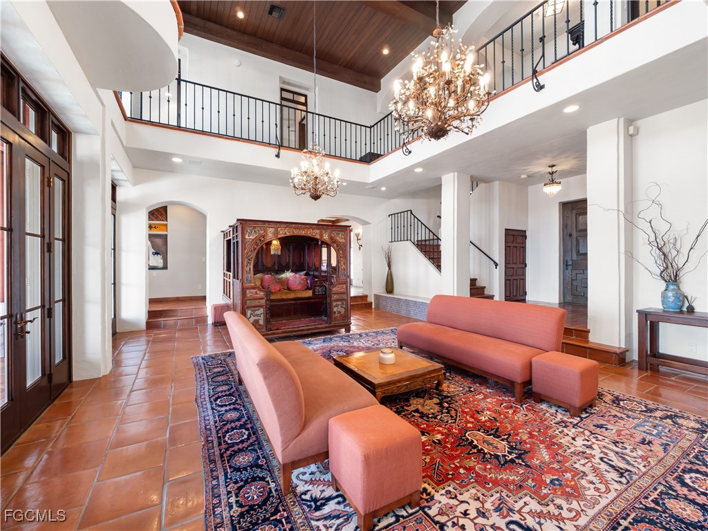 5844 Riverside Lane Fort Myers, FL 33919 - Photo 12 of 50 a living room with furniture a chandelier and a rug
