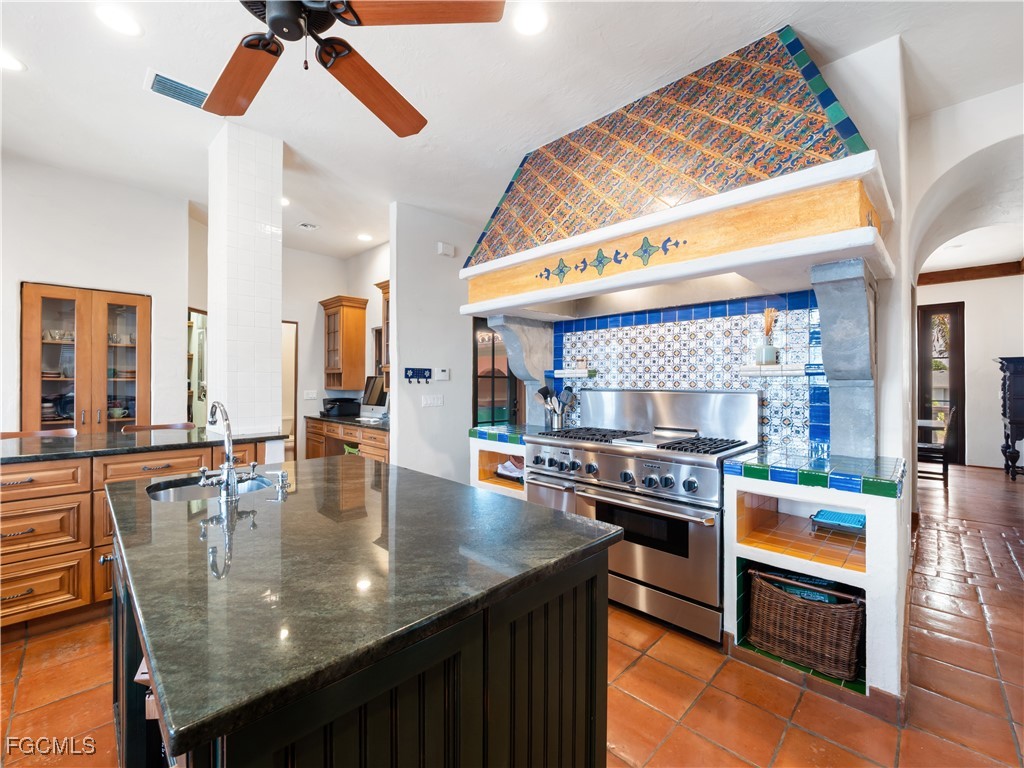 5844 Riverside Lane Fort Myers, FL 33919 - Photo 14 of 50 a kitchen with stainless steel appliances granite countertop a stove top oven a sink and dining table