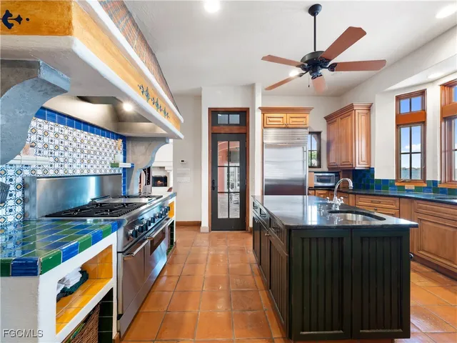 a kitchen with stainless steel appliances granite countertop a sink and a stove