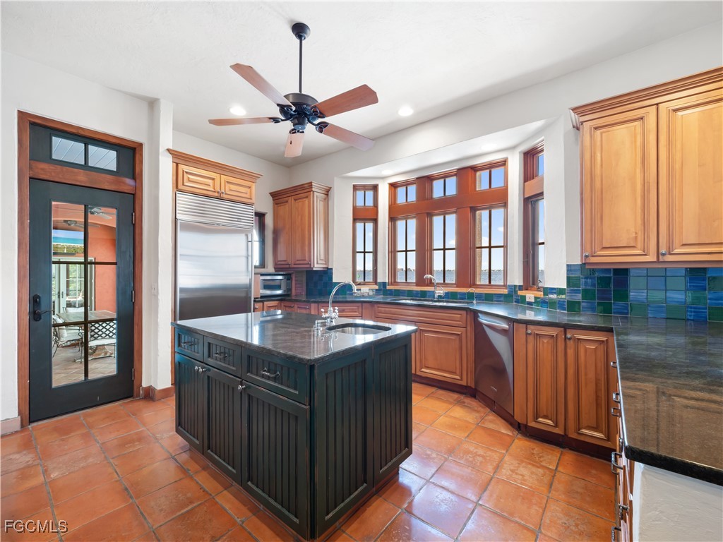 5844 Riverside Lane Fort Myers, FL 33919 - Photo 16 of 50 a kitchen with stainless steel appliances granite countertop a sink and a stove