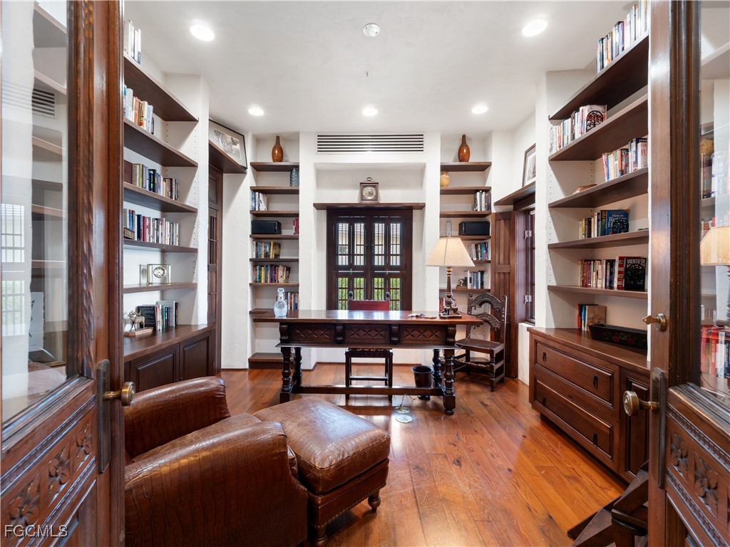 5844 Riverside Lane Fort Myers, FL 33919 - Photo 24 of 50 a living room with furniture a rug and a book shelf
