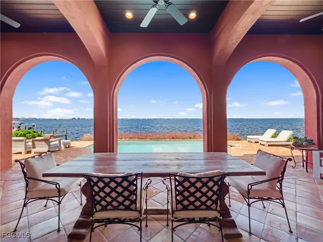 a roof deck with couches and pool table and chairs