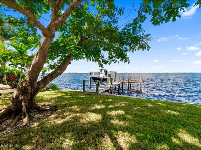 a street sign under a blue umbrella