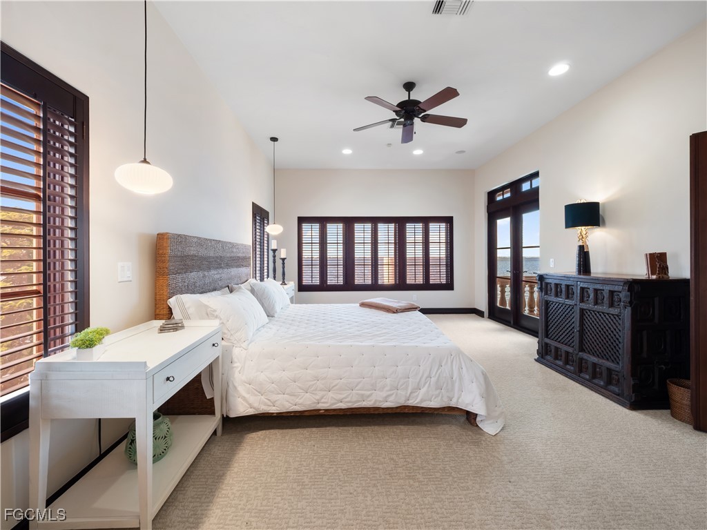 5844 Riverside Lane Fort Myers, FL 33919 - Photo 37 of 50 a bedroom with a large bed and a chandelier