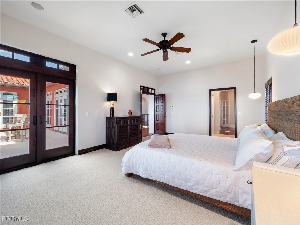 5844 Riverside Lane Fort Myers, FL 33919 - Photo 38 of 50 a bedroom with a large bed and a chandelier