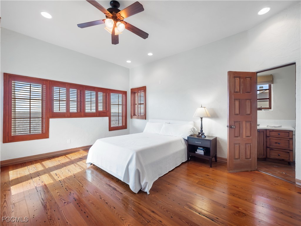 5844 Riverside Lane Fort Myers, FL 33919 - Photo 44 of 50 a spacious bedroom with a large bed and a chandelier