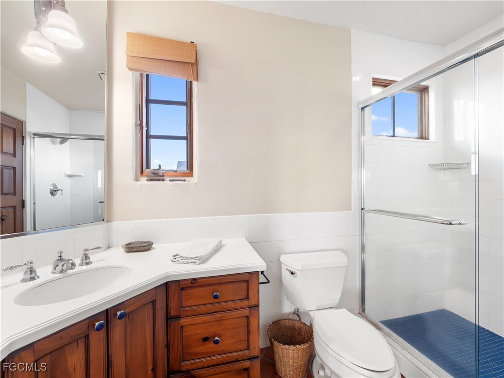 5844 Riverside Lane Fort Myers, FL 33919 - Photo 45 of 50 a bathroom with a sink vanity mirror and toilet