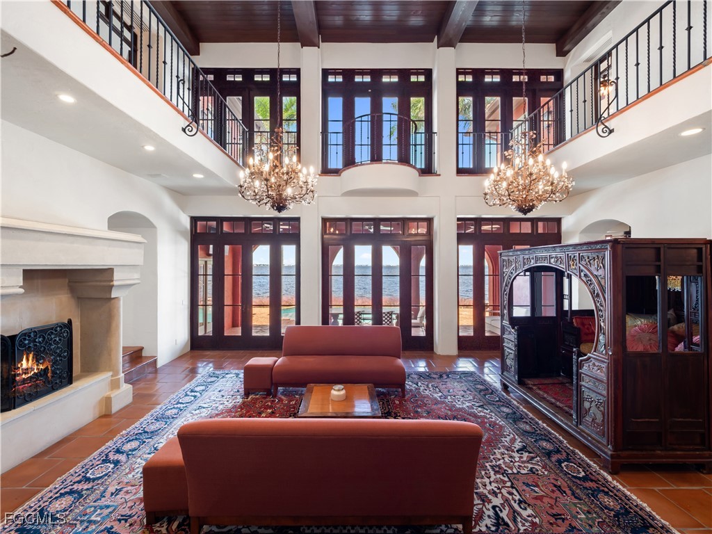 5844 Riverside Lane Fort Myers, FL 33919 - Photo 10 of 50 a living room with furniture a chandelier and a fireplace