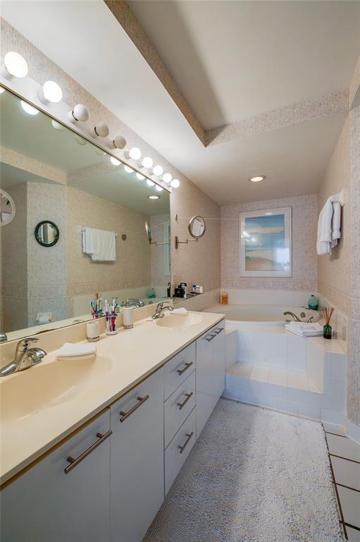 4565 South Atlantic Avenue, Unit 5708 Ponce Inlet, FL 32127 - Photo 18 of 31 a large bathroom with a sink mirror and a bath tub
