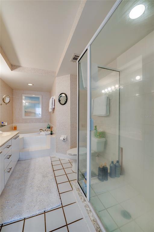 4565 South Atlantic Avenue, Unit 5708 Ponce Inlet, FL 32127 - Photo 19 of 31 a spacious bathroom with a granite countertop sink mirror and shower
