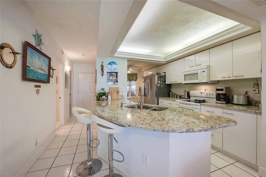 4565 South Atlantic Avenue, Unit 5708 Ponce Inlet, FL 32127 - Photo 4 of 31 a kitchen with stainless steel appliances granite countertop a sink a stove and cabinets