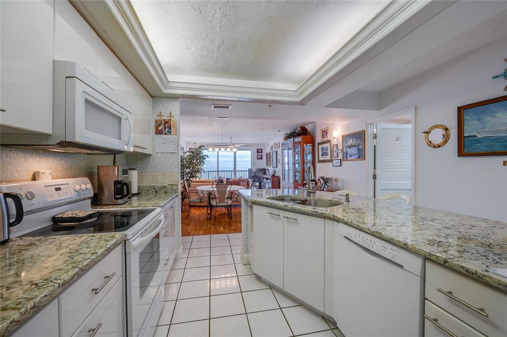 4565 South Atlantic Avenue, Unit 5708 Ponce Inlet, FL 32127 - Photo 7 of 31 a kitchen with stainless steel appliances granite countertop a sink a stove and cabinets