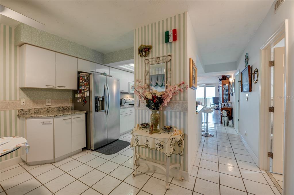 4565 South Atlantic Avenue, Unit 5708 Ponce Inlet, FL 32127 - Photo 9 of 31 a living room with furniture and a open kitchen view