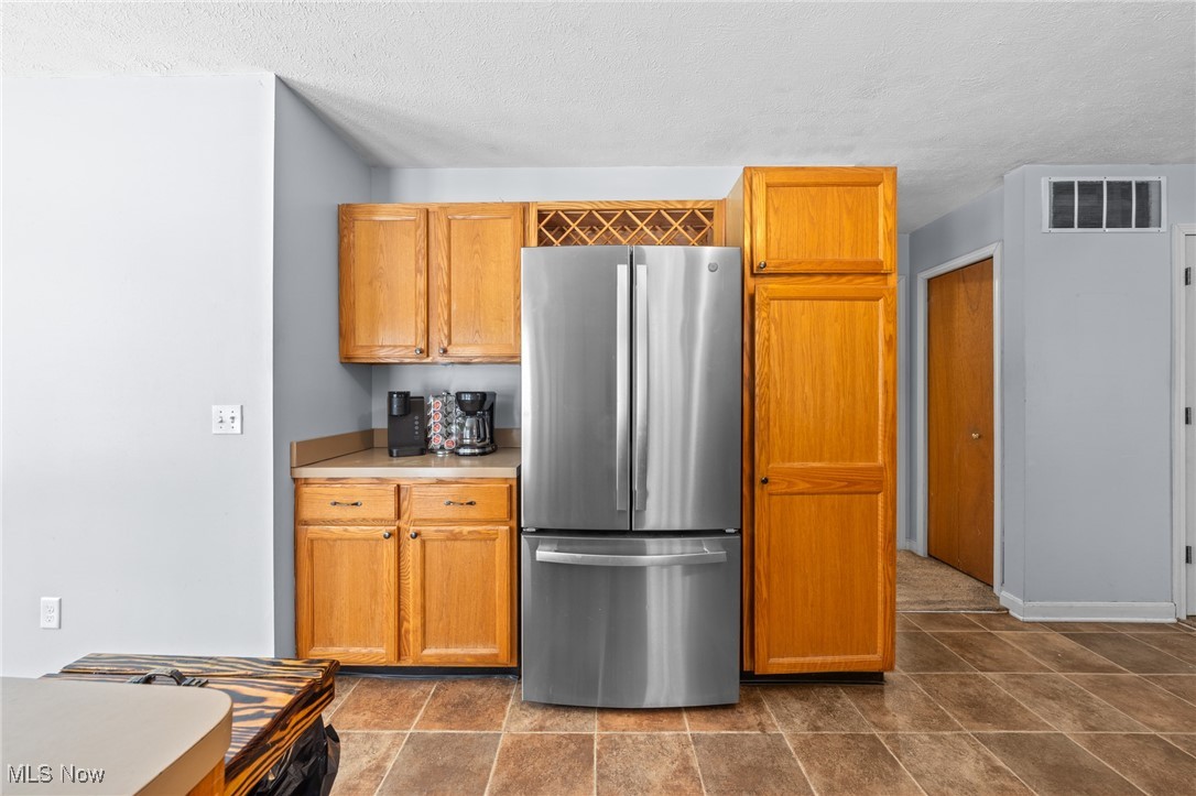 10641 Gilbert Road Newton Falls, OH 44444 - Photo 16 of 46 Kitchen with stainless steel fridge and a textured ceiling