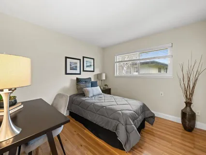 a bedroom with a bed and a table