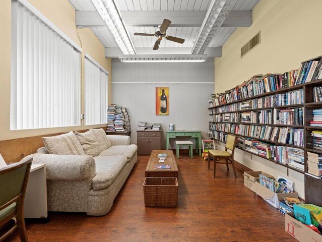 a living room with furniture and a book shelf