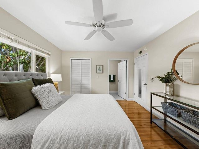 a spacious bedroom with a bed and a chandelier