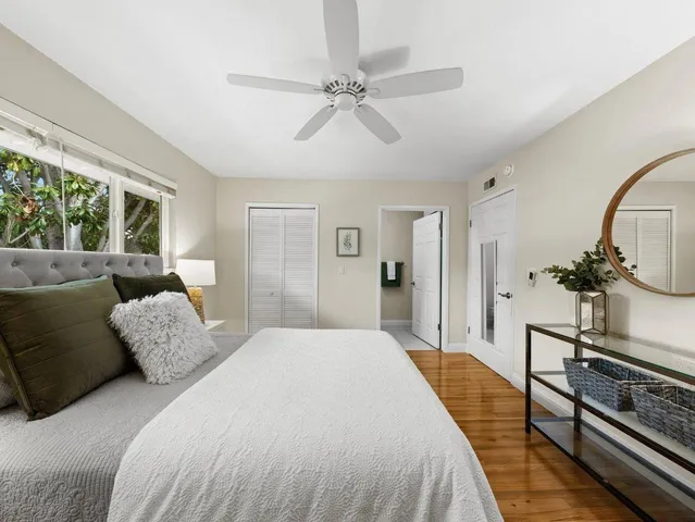 a spacious bedroom with a bed and a chandelier