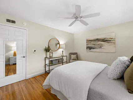 a bedroom with a large bed and a chandelier
