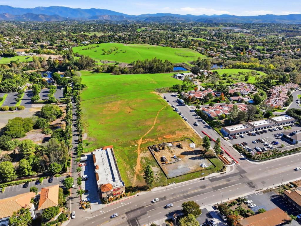 1630 South Mission Road Fallbrook, CA 92028 - Photo 19 of 34 an aerial view of a city with lots of residential buildings and mountain view in back