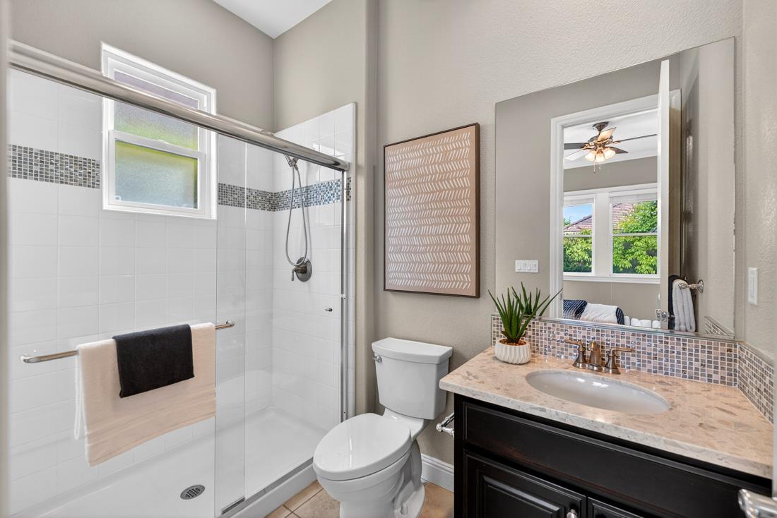 718 Timberpine Avenue Sunnyvale, CA 94086 - Photo 28 of 71 a bathroom with a granite countertop sink a toilet a mirror and shower