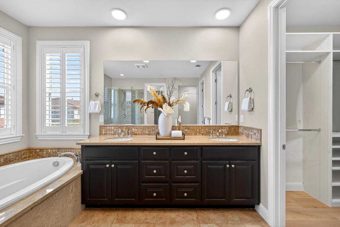 718 Timberpine Avenue Sunnyvale, CA 94086 - Photo 43 of 71 a spacious bathroom with a granite countertop double vanity sink a mirror and a bathtub