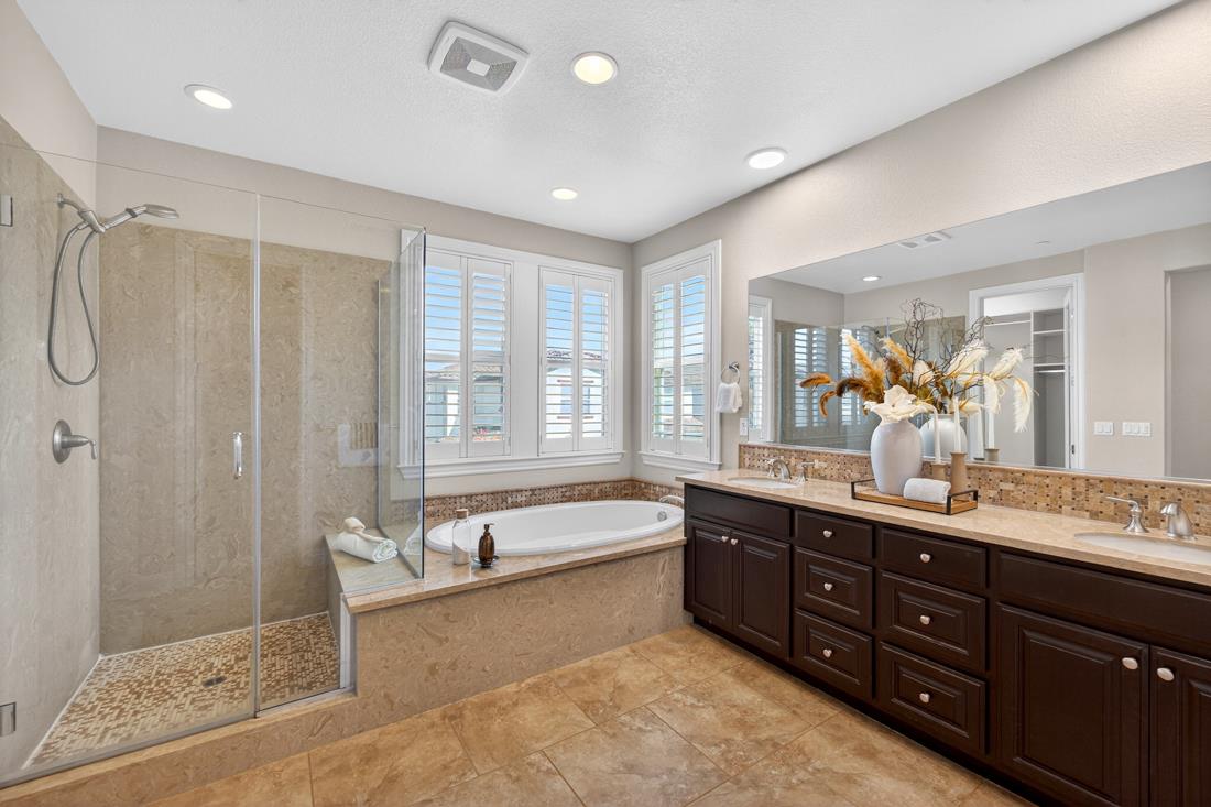 718 Timberpine Avenue Sunnyvale, CA 94086 - Photo 48 of 71 a spacious bathroom with a double vanity sink a large mirror and a bathtub with shower