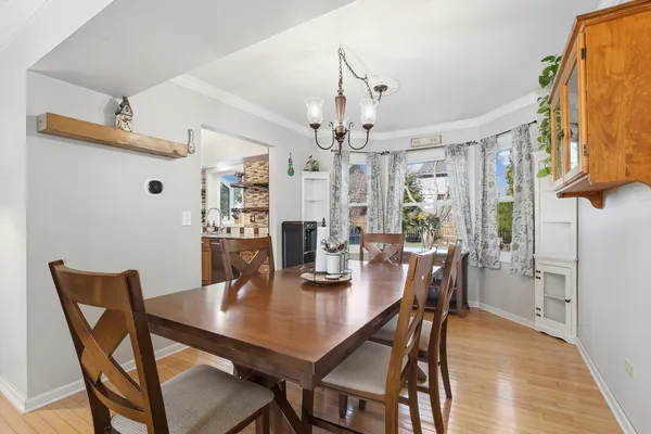 a view of a dining room with furniture and wooden floor