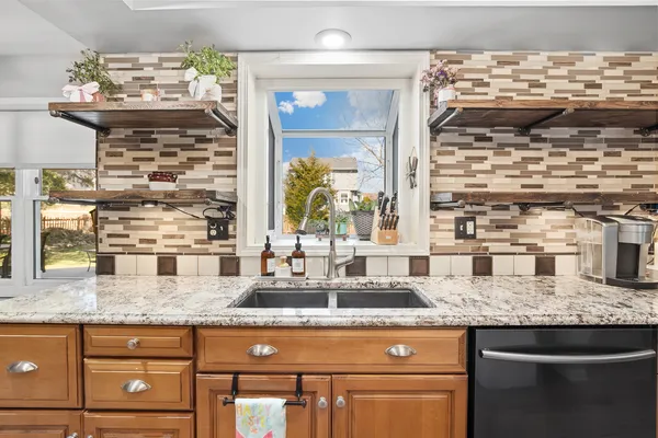 a bathroom with granite countertop a sink and a wooden floor