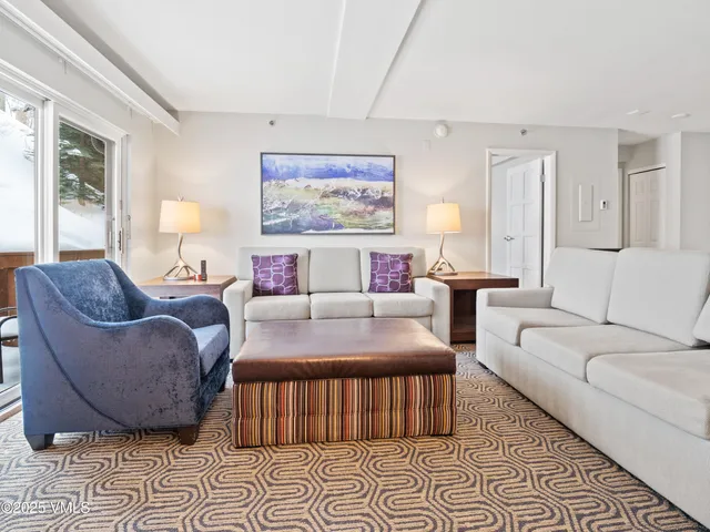 a living room with furniture and a rug