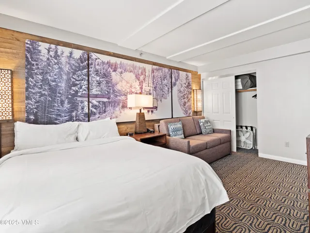 a bedroom with a large bed and a large window